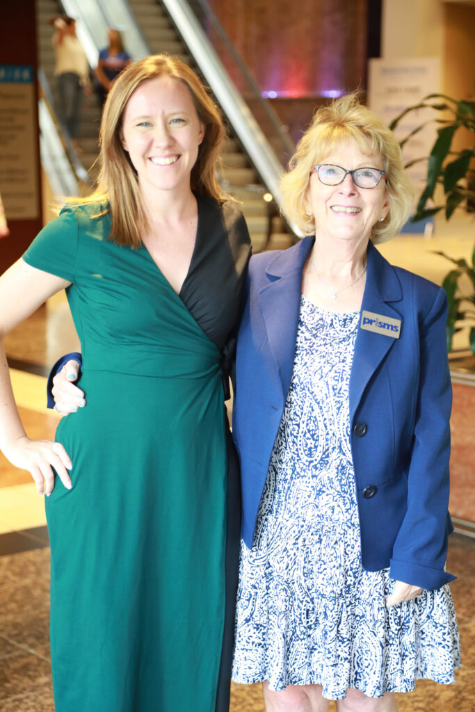 Two women pose for a photo 