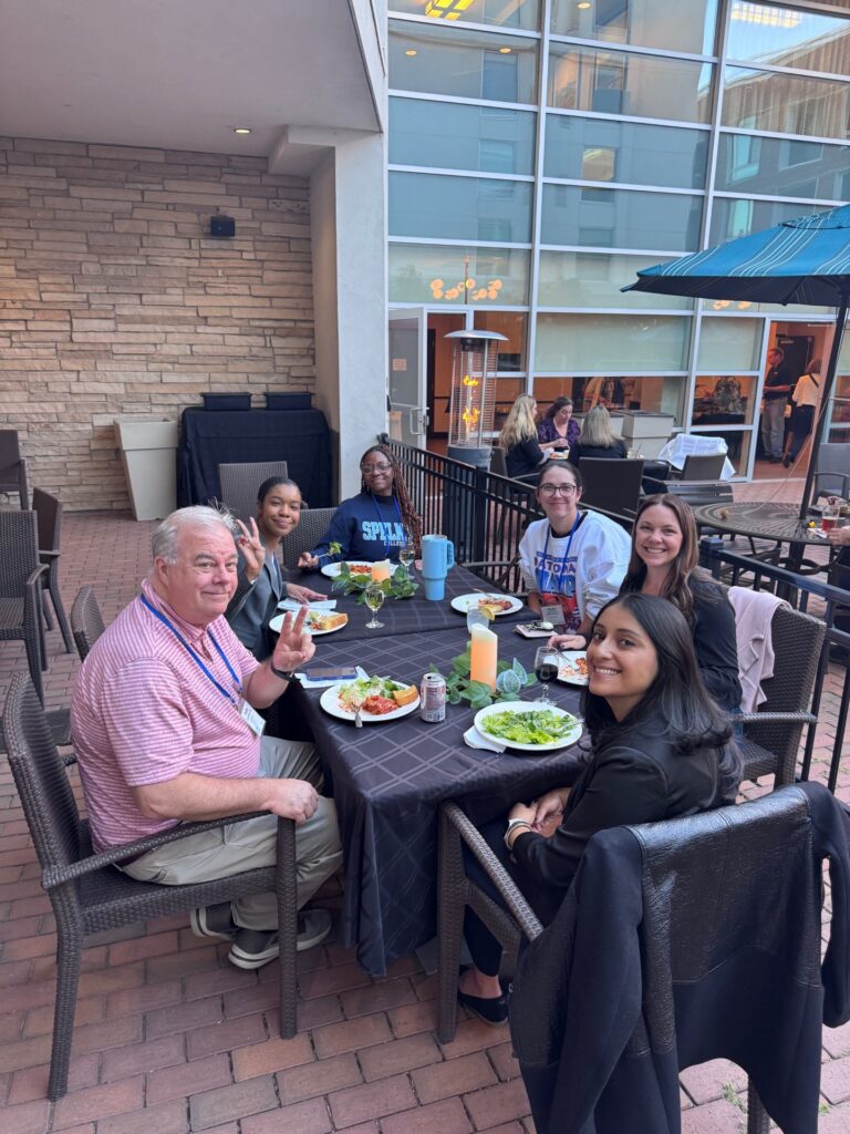 A group enjoys dinner together at the SMS Research Symposium